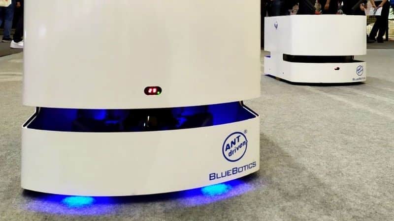 A fleet of mini lite mobile robots at an automation tradeshow